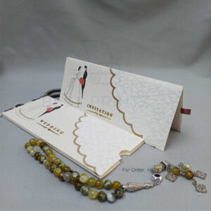 ornate white wedding invitation with embossed floral patterns (copy)