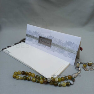 ornate white wedding invitation with embossed floral patterns (copy)