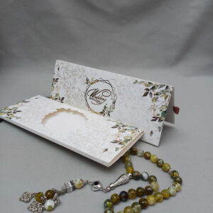 ornate white wedding invitation with embossed floral patterns (copy)