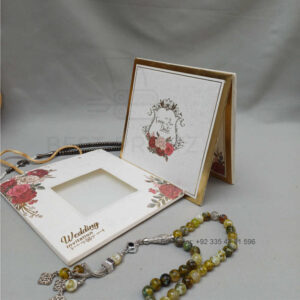 ornate white wedding invitation with embossed floral patterns (copy)