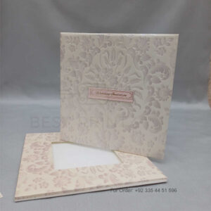 a white envelope containing a wedding invitation card tied with a string (copy)
