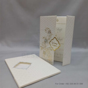 a white envelope containing a wedding invitation card tied with a string (copy)